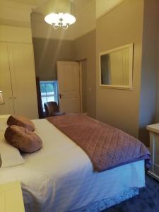 a bedroom with a bed with two pillows on it at Bolands Self Catering Accommodation in Hacketstown
