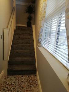 a staircase in a house with a window at Bolands Self Catering Accommodation in Hacketstown