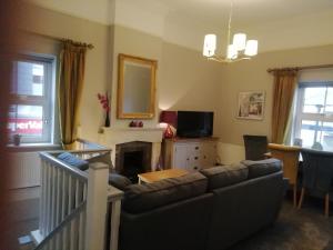 a living room with a couch and a fireplace at Bolands Self Catering Accommodation in Hacketstown