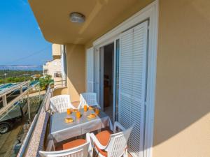 a balcony with a table and chairs on a balcony at Apartments Adria in Dramalj