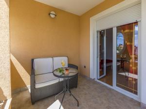 a room with a table and a chair and a glass door at Apartments Pekera in Selce