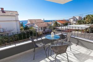 a patio with a table and chairs on a balcony at Apartments Karmen 2 in Crikvenica