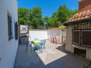 a patio with chairs and a table and a fence at Apartments Ankica in Crikvenica