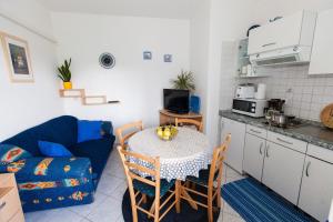 a living room with a table and a kitchen at Apartment Karla in Bribir