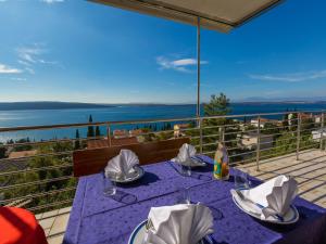 a table on a balcony with a view of the water at Apartments Dubravka in Crikvenica