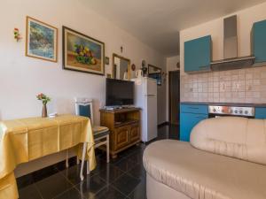 a living room with a couch and a table and a kitchen at Apartments Dubravka in Crikvenica