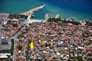 an aerial view of a city with a yellow arrow at House Haus Marijo in Crikvenica