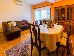 a living room with a table and a couch at Apartment Agava in Bribir