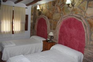 Postel nebo postele na pokoji v ubytování Casa Rural Laura