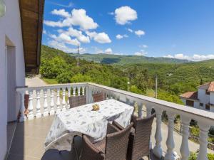 a table and chairs on a balcony with a view at Villa Summertime in Crikvenica