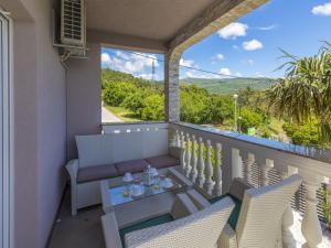 a balcony with a table and chairs and a view at Villa Summertime in Crikvenica