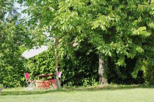 a picnic table under two trees in a park at La Casa di Muro in Oriolo Romano +21 photos