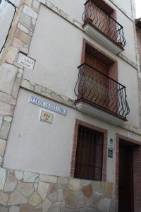 a building with a balcony and a sign on it at Casa Rural Laura in Villafeliche