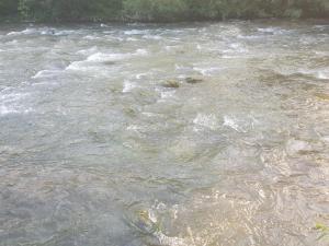 a river with a bunch of waves in the water at Sam guest house in Jajce