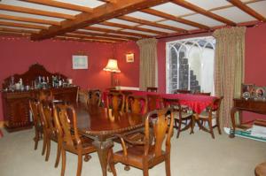 a dining room with a table and chairs at Clemenstone House B&B in Cowbridge