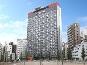 a large building with a hotel sign on top of it at APA Hotel Yamanote Otsuka Eki Tower in Tokyo