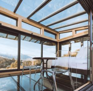 a glass house with a view at Kahutara PurePod in Kaikoura