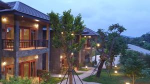 a building with lights on the side of it at Chiang Klong Riverside Resort in Chiang Khan