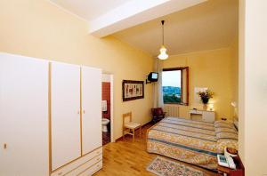Postel nebo postele na pokoji v ubytování Hotel Risorgimento