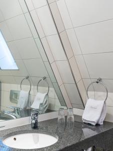 a bathroom with a sink and a mirror at Hotel Domschenke in Billerbeck