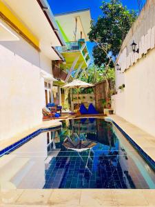 an image of a swimming pool in a house at Lara Homestay in Kuta Lombok