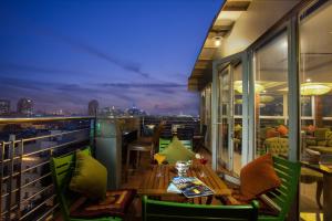 a balcony with a table and chairs with a view of the city at Golden Silk Boutique Hotel in Hanoi