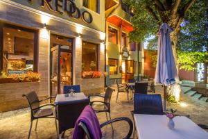 an outdoor restaurant with tables and a umbrella at Hotel Villa Boyana - Free Parking in Sofia