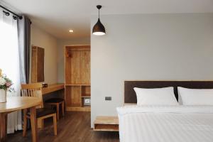 מיטה או מיטות בחדר ב-Peppy Hotel-pepperyhills hotel