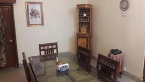 a room with two chairs and a glass table at Rampura Kothi in Jaipur +22 photos