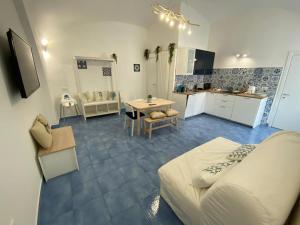 a living room and kitchen with a couch and a table at Villa Spring Apartments in Meta