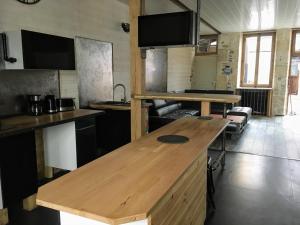 a kitchen with a wooden counter top in a room at La Rénovée d’Antan in Avallon