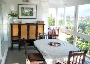 a dining room with a table and chairs and windows at Haus mit Pool Altea in Altea
