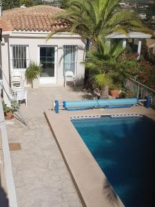 a swimming pool with blue inflatables in front of a house at Haus mit Pool Altea in Altea