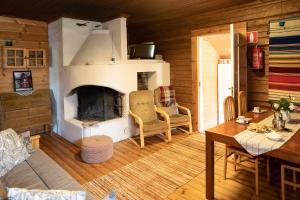 a living room with a fireplace and a table and chairs at Valkeisen Loma in Ähtäri