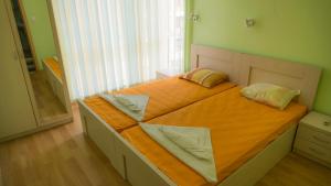 a bed with two pillows on it in a room at Hotel Darius in Sunny Beach