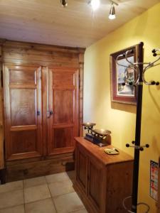 a room with a wooden cabinet and a table at Le Grenier in Bief-des-Maisons