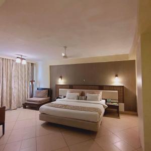 a large bedroom with a large bed and a couch at Silverador Resort in Thane +42 photos