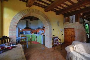 una sala de estar con cocina y un arco en una casa en Il Casale Dorato, en Filottrano