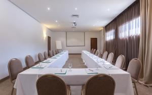a conference room with rows of tables and chairs at Hotel Nour Congress & Resort in Bizerte