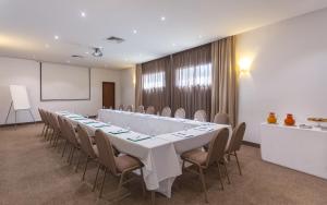 a large meeting room with a long table and chairs at Hotel Nour Congress & Resort in Bizerte