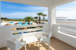 a balcony with a table and chairs and a view of the beach at Hotel Nour Congress & Resort in Bizerte