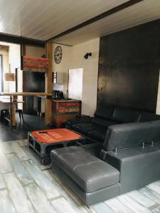 a living room with a couch and a table at La Rénovée d’Antan in Avallon