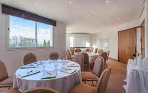 a conference room with tables and chairs and a window at Hotel Nour Congress & Resort in Bizerte