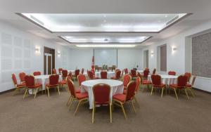 a conference room with tables and chairs and a podium at Hotel Nour Congress & Resort in Bizerte