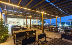 a restaurant patio with tables and chairs and lights at Hotel Nour Congress & Resort in Bizerte