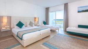 a hotel room with a bed and a couch at Hotel Nour Congress & Resort in Bizerte