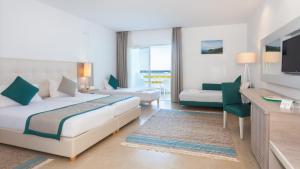 a hotel room with a bed and a television at Hotel Nour Congress & Resort in Bizerte