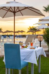a table with a plate of food and an umbrella at Hotel Nour Congress & Resort in Bizerte