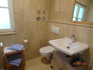 a bathroom with a sink and a toilet at Huge and Calm Apartment in Central Garmisch in Garmisch-Partenkirchen