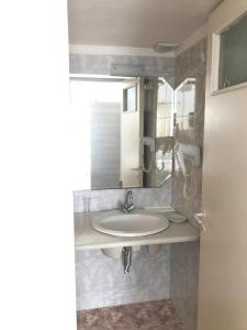 a bathroom with a sink and a mirror at Romantika in Platis Gialos